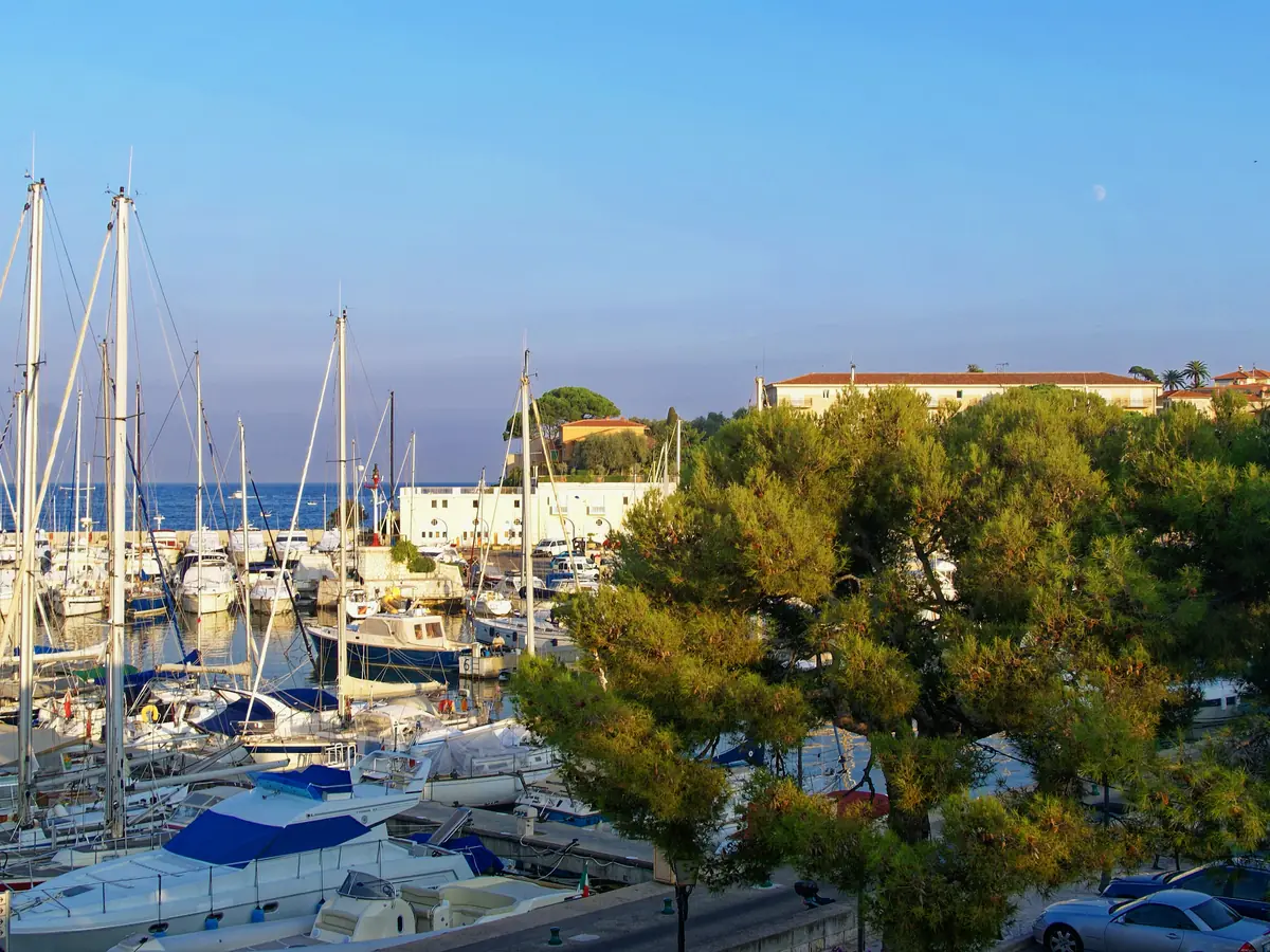 Le port de Saint-Jean-Cap-Ferrat, voiliers et pins devant les rochers
